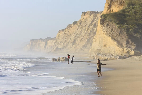 Kids playing on beach. Santa Cruz coast, California, US. Hazy day at the Beach