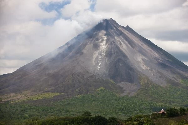 Lava rocks are thrown from the erupting Arenal volcano to the mountainside and forest