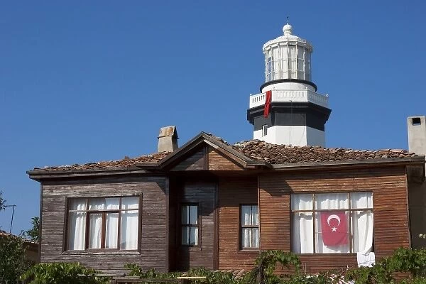 Lighthouse of Sile as seen behind an old wooden house, Istanbul, Turkey