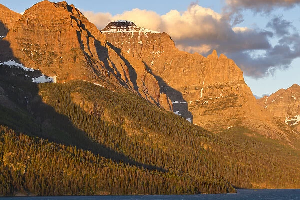 Mahtotopa and Little Chief Mountains looms over St Mary Lake at sunrise in Glacier National Park