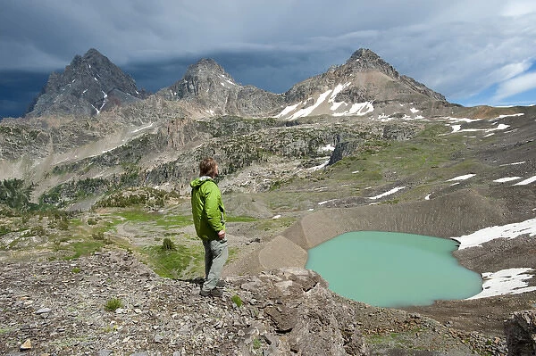 Man enjoys View of Lake, Teton Crest Trail, three Tetons, Schoolroom Glacier