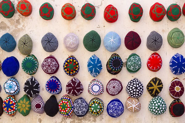 Morocco, Essaouira. Colorful mens hats (tagiya) hanging on wall