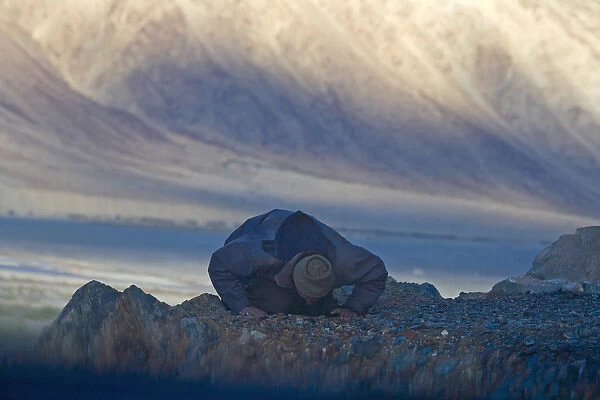 Muslim praying towards the west at dusk in the Karakorum, Nubra, Ladakh, India