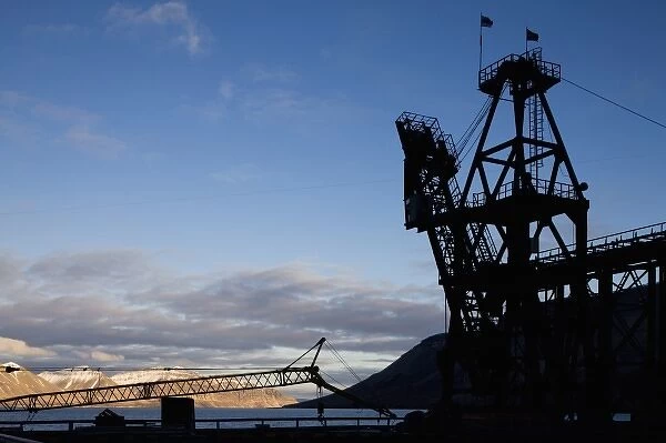 Norway, Svalbard, Pyramiden, Silhouette of loading crane along waterfront at abandoned