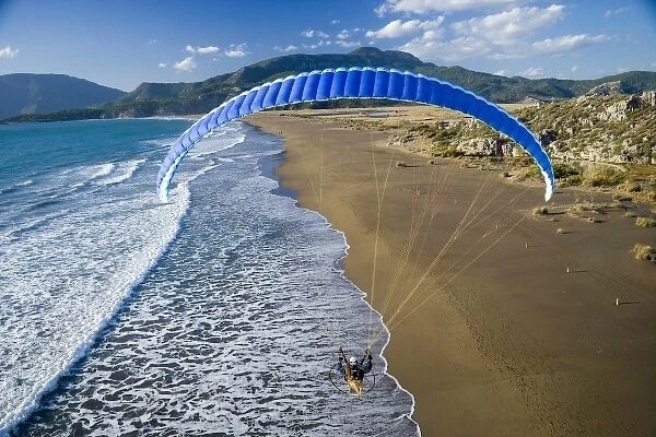 Powered paraglider flying over beach in Dalyan, aerial view, Koycegiz, Mugla, Turkey