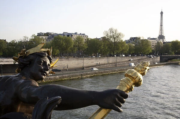 The sculpture on the Pont Alexandre III with River Seine and Eiffel Tower in the background