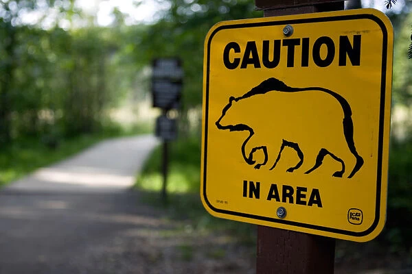 A sign warns visitors about bear danger near Laird River in Hotsprings Provincial Park