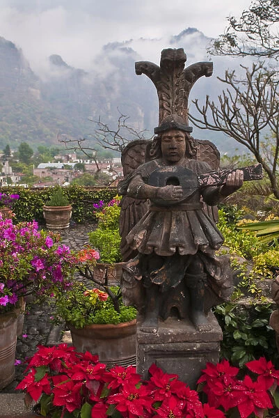 South America, Mexico, Tepoztlan. Flower pots in garden with statue. Credit as: Nancy