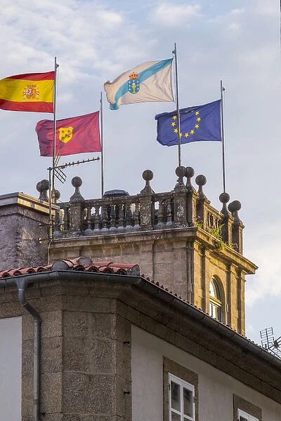 Spain, Santiago. European union and Portugal Flags flying atop a tower near the Cathedral