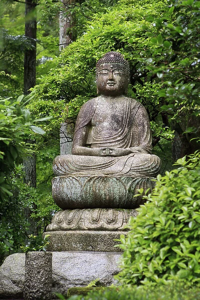 A stone Buddha statue in the grounds of Ryoan-Ji Temple in Kyoto, Japan