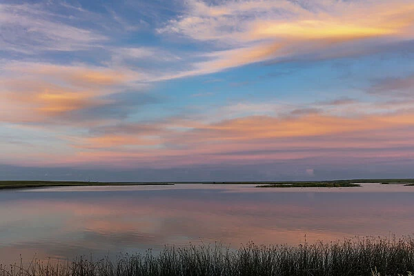 Sunset clouds reflection at Medicine Lake National Wildlife Refuge, Montana, USA