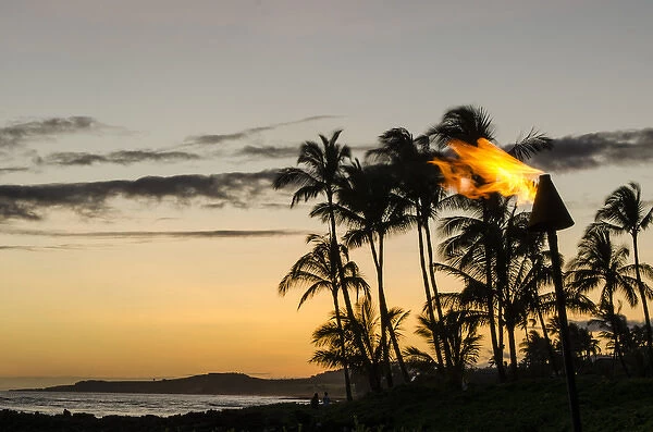 Tiki torches at Sunset on Poipu beach Kauai, Hawaii