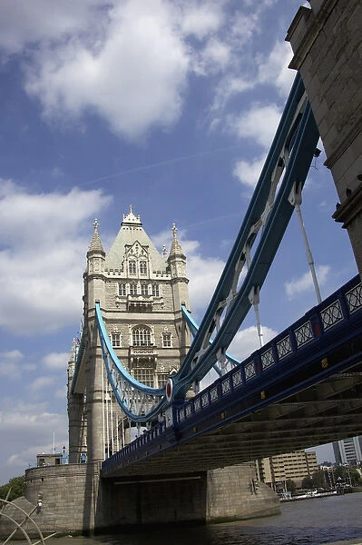 The Tower Bridge in London, England on a beautiful day with blue clouds and white