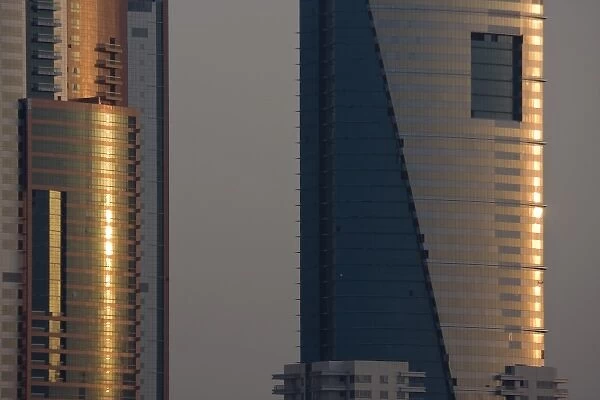 UAE, Dubai, Media City. Reflections on glass of Al Salam Tecom Tower in Media City