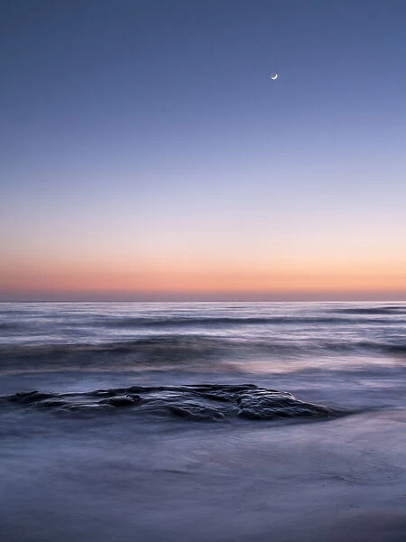 USA, California, La Jolla, Crescent moon at twilight over Windansea Beach
