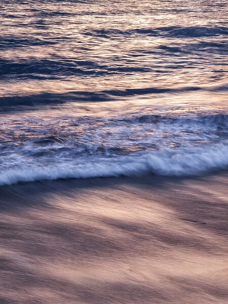 USA, California, La Jolla, Sunset color reflected in waves at Windansea Beach