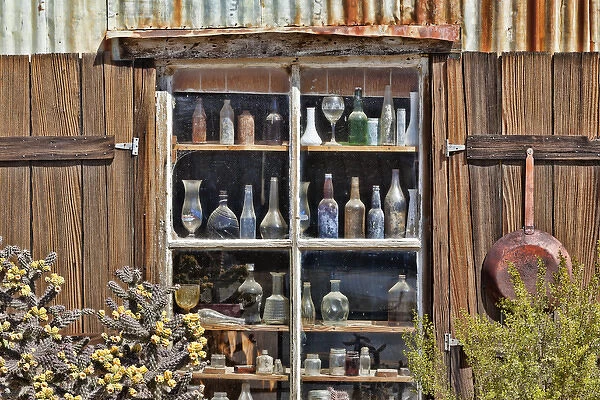 USA, California, Randsburg. Bottles in window of abandoned store