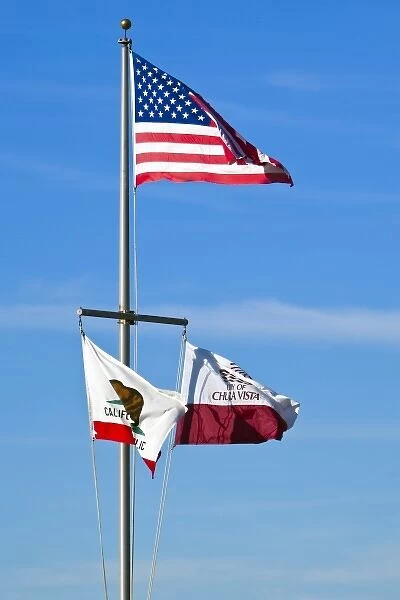 USA, California, San Diego, Chula Vista. Federal, state, and local flags fly on flagpole