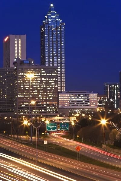 USA, Georgia, Atlanta. Atlanta skyline at dusk with Freedom Parkway in the foreground