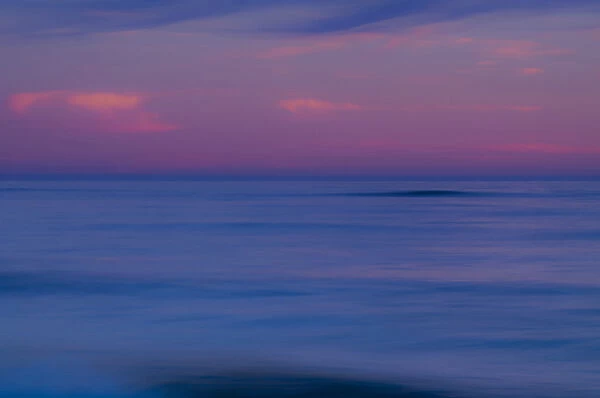 USA, New Jersey, Cape May. Purple-colored sunrise on ocean shore