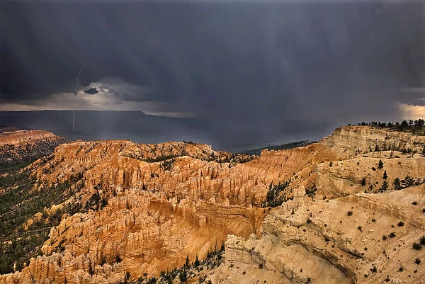 USA, Utah, Bryce Canyon National Park. Sunrise on storm clouds and sandstone hoodoo formations