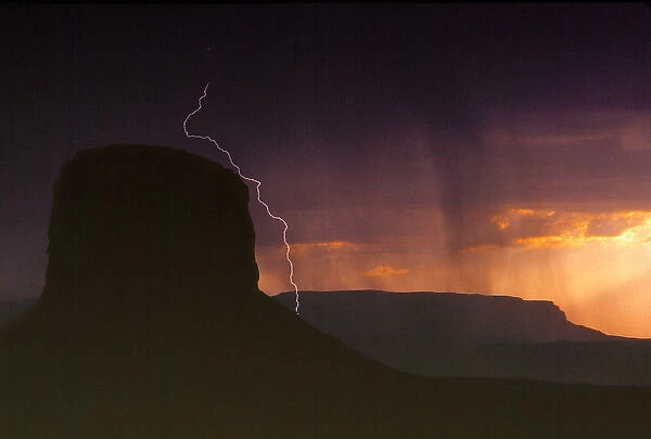 USA, Utah, Monument Valley. An afternoon lightning and thunderstorm darkens the sky