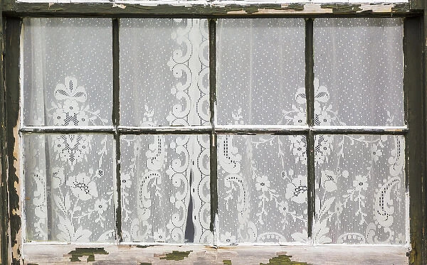 USA, Washington, Port Townsend. Lace curtains in window