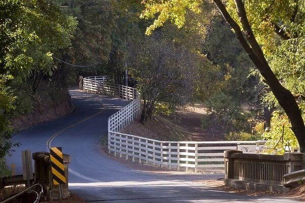 White fence curves alongside Westside Road, Sonoma, California, USA