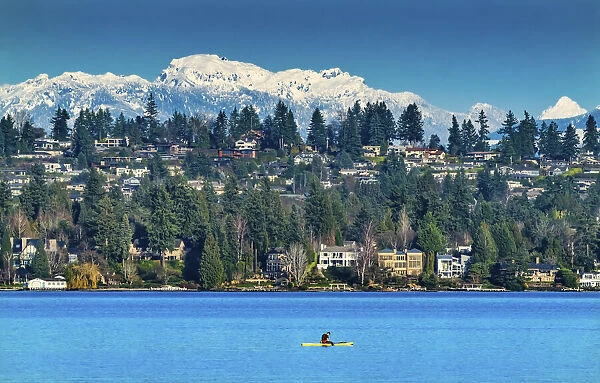 Yellow canoe and houses, Lake Washington and snowcapped Cascade Mountains, Bellevue