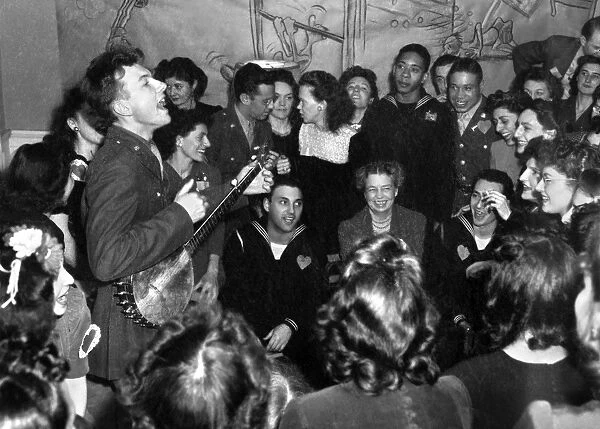 American folk singer and composer. Performing at the opening of the Washington D. C. labor canteen, sponsored by the United Federal Labor Canteen and the Congress of Industrial Organizations (CIO). Eleanor Roosevelt is in the audience. Photograph by Joseph Horne, 1944