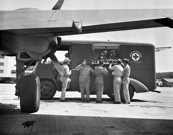 An American Red Cross mobile canteen serving airmen at a base near Washington, D. C. Photograph, c1941-42