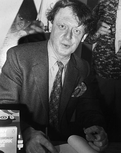 ANTHONY BURGESS (1917-1993). English writer. Burgess signing copies of his book, A Clockwork Orange, at the Cannes Film Festival where the film made by Stanley Kubrick was screened. Photograph, 16 May 1971