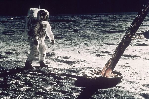 APOLLO 11: LUNAR MODULE. Edwin Buzz Aldrin stands beside LM strut and probe