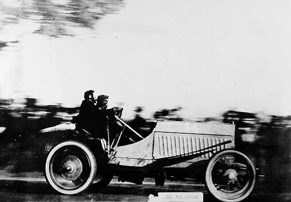 AUTOMOBILE: RACING, 1905. An early automobile racer photographed while driving