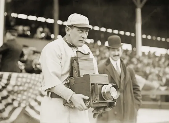 Framed Print : Print of a baseball player holding a camera, c1911 Framed Print : Print of a baseball player holding a camera, c1911