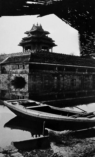 BEIJING: SUMMER PALACE. Row boat in front of surrounding wall at the Summer Palace