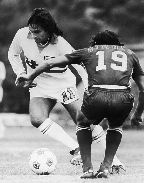 BEST & SIMOES, c1977. George Best of the L. A. Aztecs competes for the ball against Antnio Simes of the San Jose Earthquakes, c1977