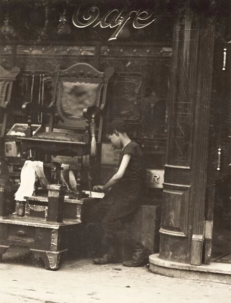 BOOTBLACK, 1910. A young bootblack working on Canal Street in New York City