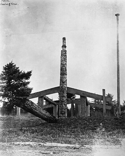 CANADA: HAIDA TOTEM POLE. Totem pole topped by a figure in a tall hat, in front