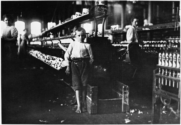CHILD LABOR, 1910. An eight year old boy who picks up bobbins for 15 cents a day