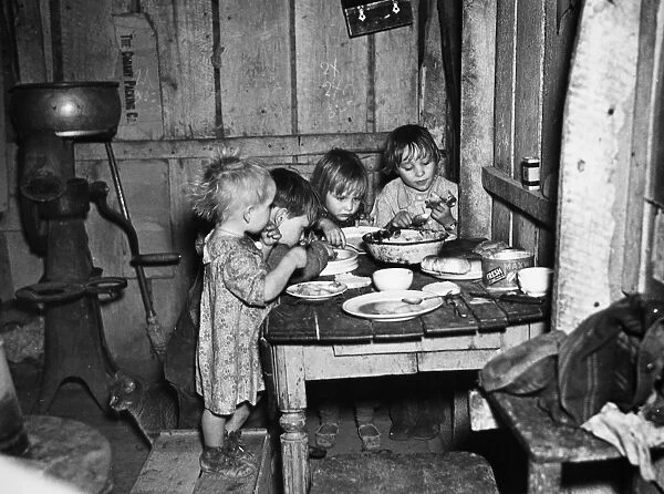 CHRISTMAS POOR, 1936. A Christmas Day dinner of potatoes, cabbage and pie at the home of Earl Pauley, Smithfield, Iowa, 1936. Photograph by Russell Lee