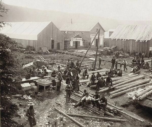 DAWSON CITY, c1897. Construction workers seated on logs taking a break at the gold