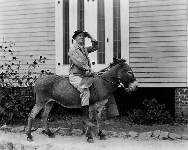 DONKEY RIDING. Actor Charles Murray as a prospector riding a donkey. Motion picture still