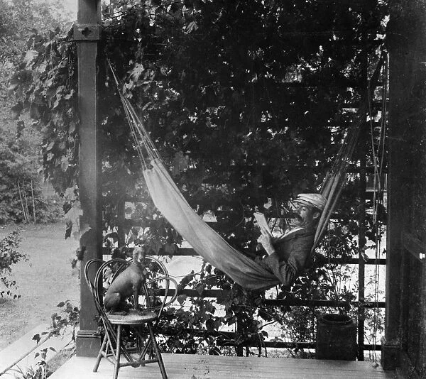 HAMMOCK, 1893. A men resting in a hammock on the porch of his home in Minnesota