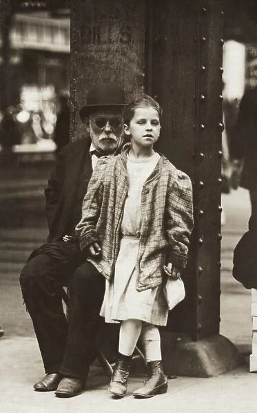 HINE: BEGGARS, 1910. An old man and young girl begging on 14th Street and 6th Avenue