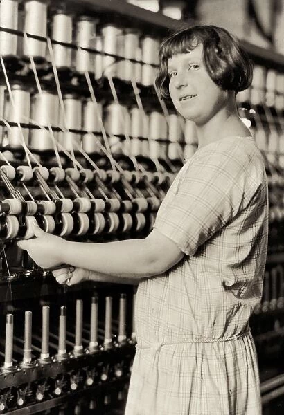 HINE: CHILD LABOR, 1924. A young worker using textile machinery at the Cheney Silk