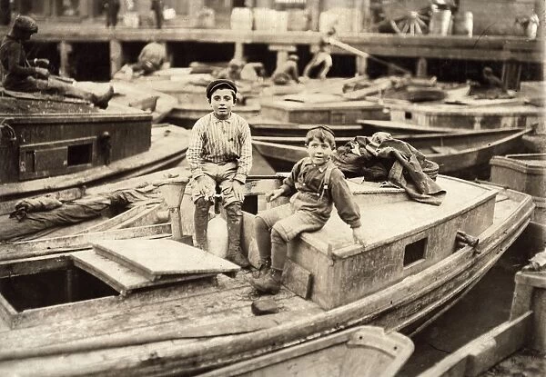 HINE: TRUANT, 1909. Two truants hanging around fishing boats in the harbor during