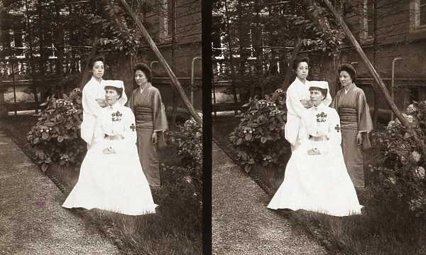 JAPAN: RED CROSS, c1905. A Western Red Cross worker poses with two Japanese women in a garden