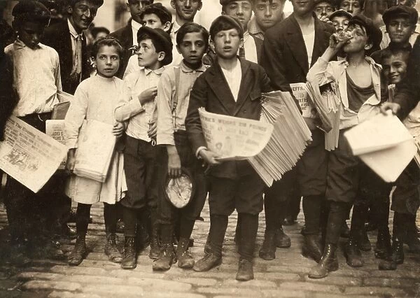 NEW YORK: NEWSBOYS, 1910. A group of newboys and one newsgirl getting the afternoon