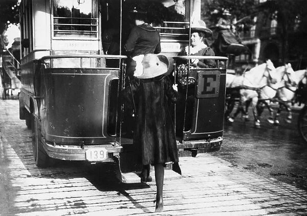 PARIS: OMNIBUS, c1920. A woman boards an omnibus in Paris, France. Photograph, c1920